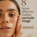 Femme appliquant de l'huile pour le visage sur sa peau avec douceur, révélant son éclat naturel.